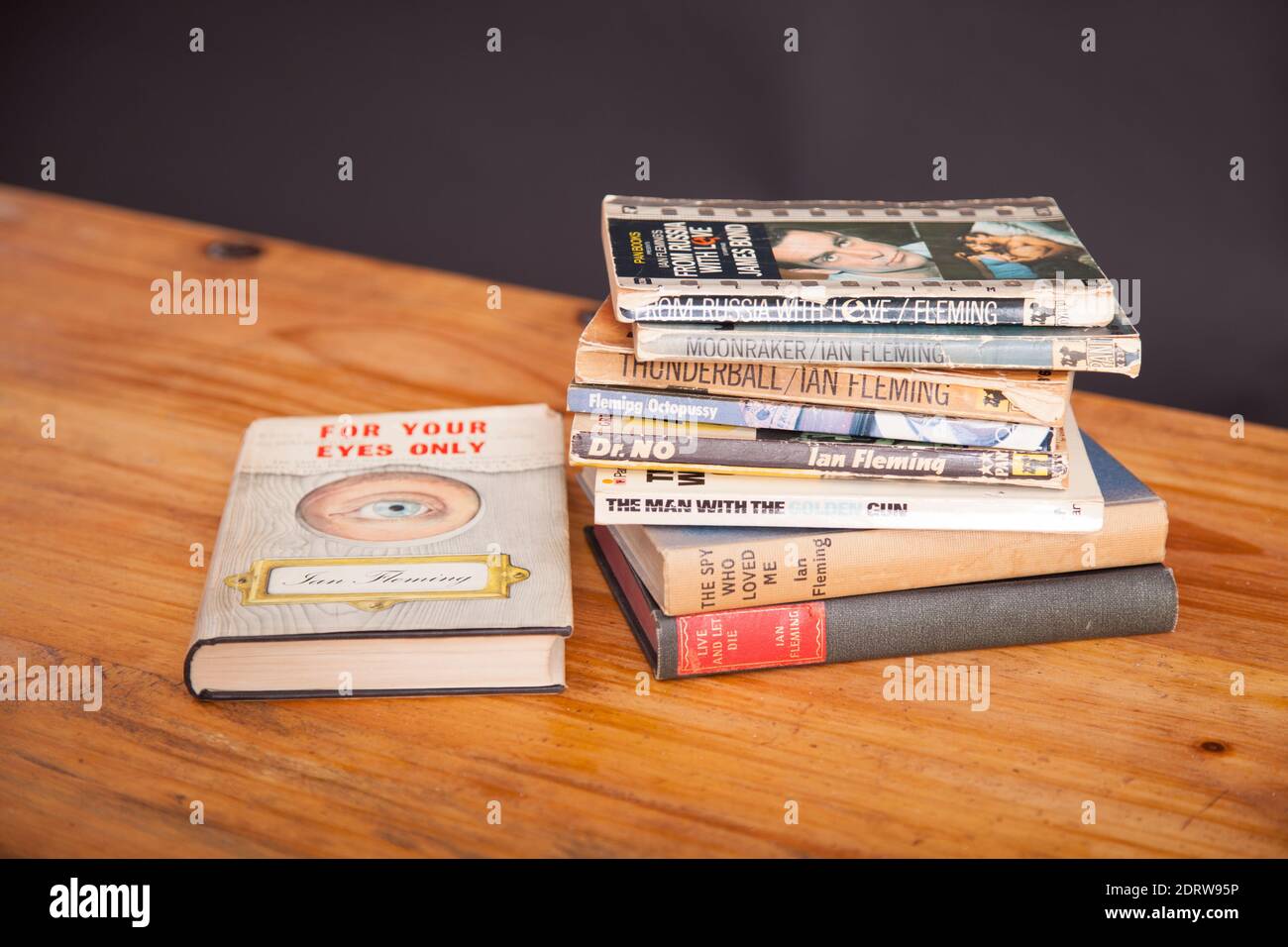 A stack of vintage James Bond 007 books on wooden table Stock Photo