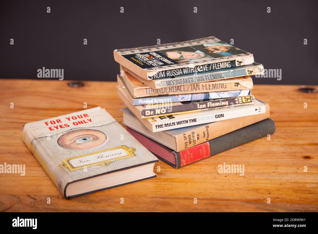 A stack of vintage James Bond 007 books on wooden table Stock Photo