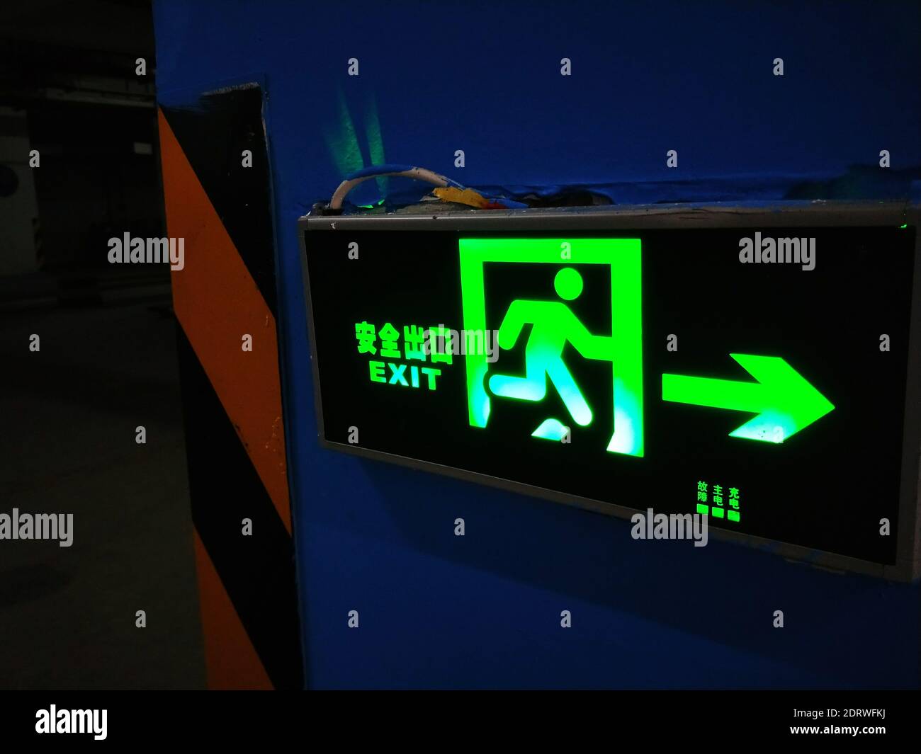 Close-up Of Illuminated Exit Sign On Wall Stock Photo