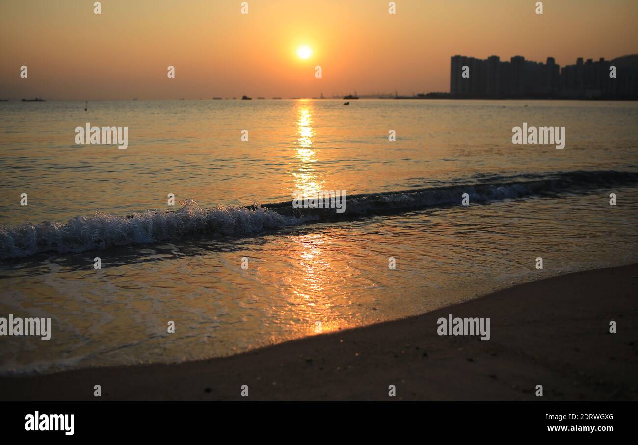 sunset with the waves on the beach in Golden Beach hong kong Stock ...