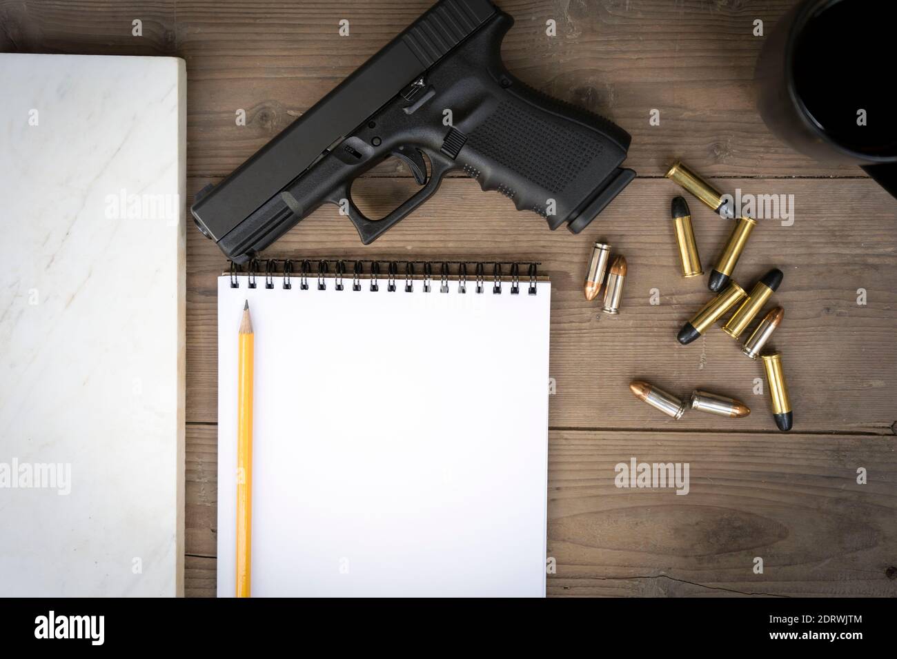 Directly Above Shot Of Handgun And Bullets With Book On Table Stock Photo -  Alamy