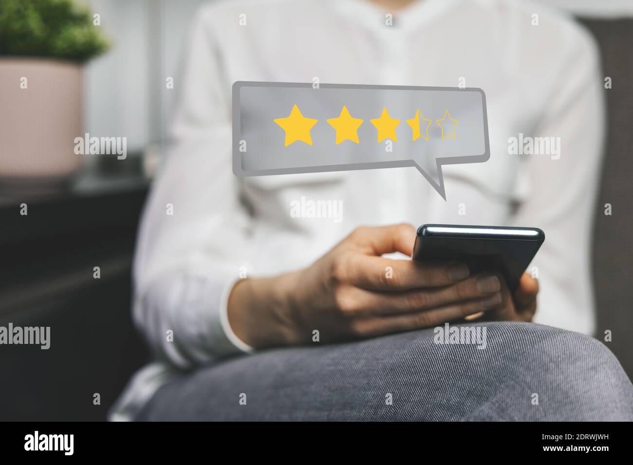 customer review - woman using phone to give feedback and rate her experience with stars about service or product quality Stock Photo