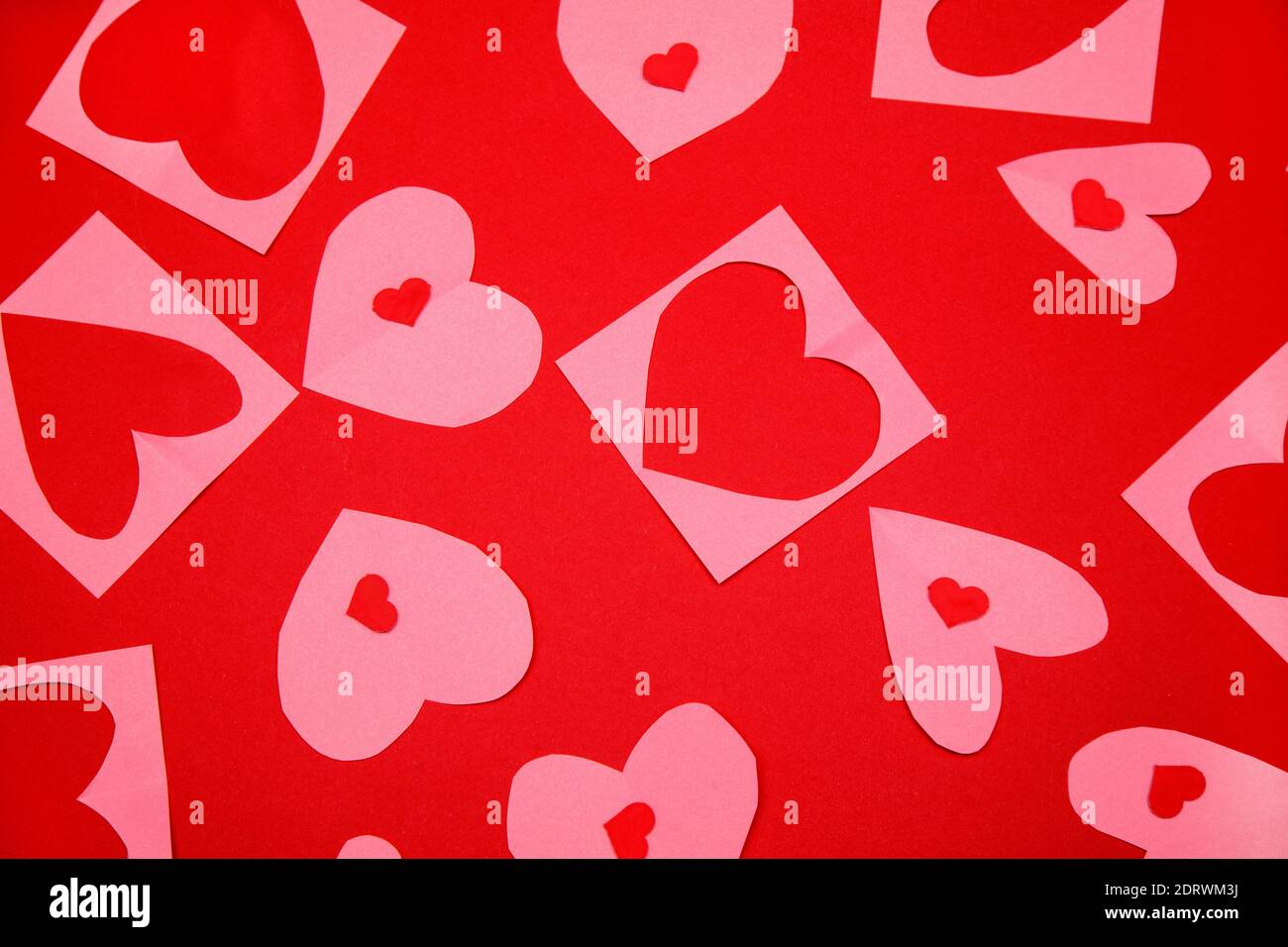 Background Of Lot Of Identical Red Pink Cut Out Paper Hearts Lying Background of lot of identical red pink cut out paper hearts lying