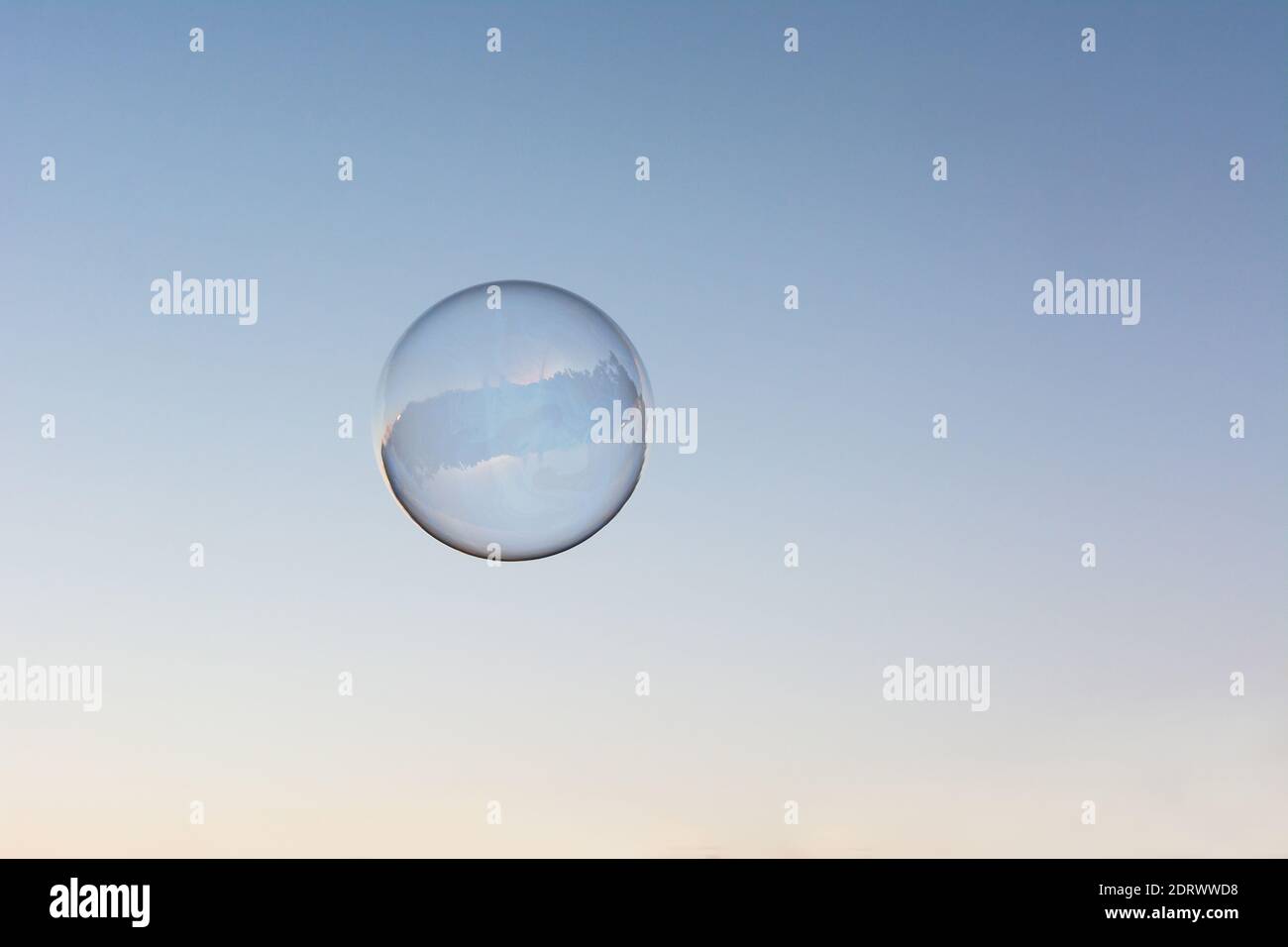 A soap bubble flying in the blue and clean sky Stock Photo - Alamy