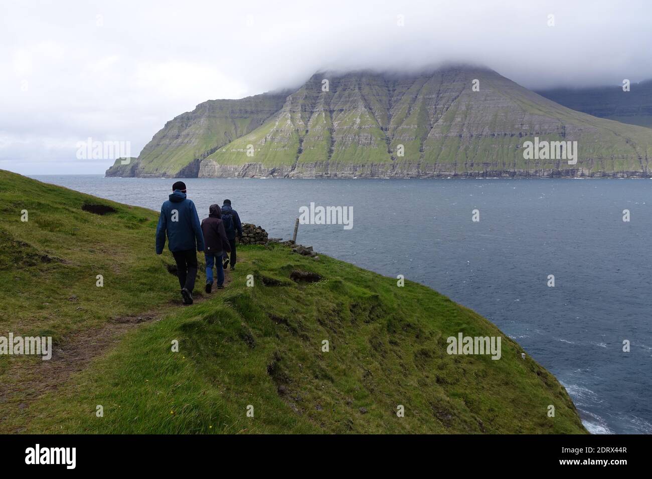 Three boys hiking at the fjord Stock Photo