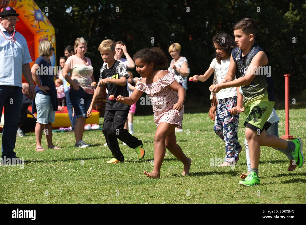 Children playing egg and spoon race in the park in Nechells, Birmingham