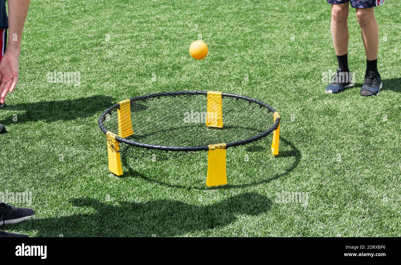 Low Section Of Man Playing With Ball On Trampoline Stock Photo - Alamy