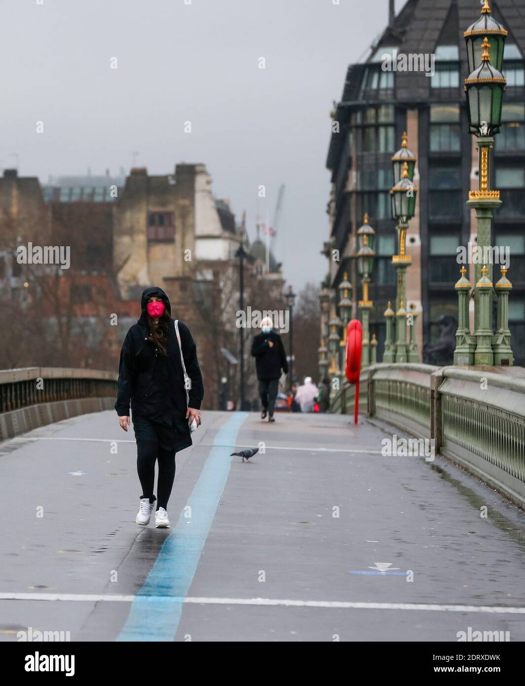 London, UK. 21st Dec, 2020. People walk along Westminster Bridge in London, Britain on Dec. 21, 2020. On Sunday, British Health Secretary Matt Hancock warned that the new strain of COVID-19 is 'out of control' in Britain, urging Britons to behave as if they already have the virus, especially in areas under the new Tier Four restrictions. Credit: Han Yan/Xinhua/Alamy Live News Stock Photo