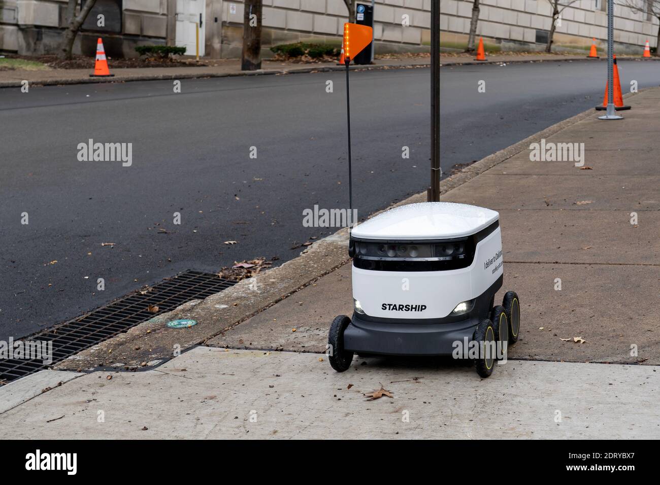 A Starship food delivery robot is driving on the sidewalk in University of Pittsburgh campus in Pittsburgh, PA, USA. Stock Photo