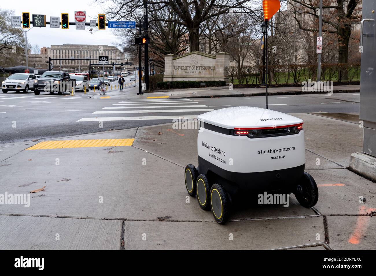 A Starship food delivery robot is driving on the sidewalk in University of Pittsburgh campus in Pittsburgh, PA, USA. Stock Photo