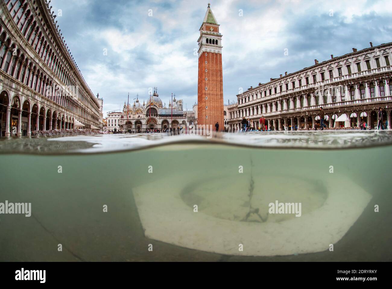 Half underwater half above photo of St. Mark's Square flooded by high tide. Venice, Italy Stock Photo
