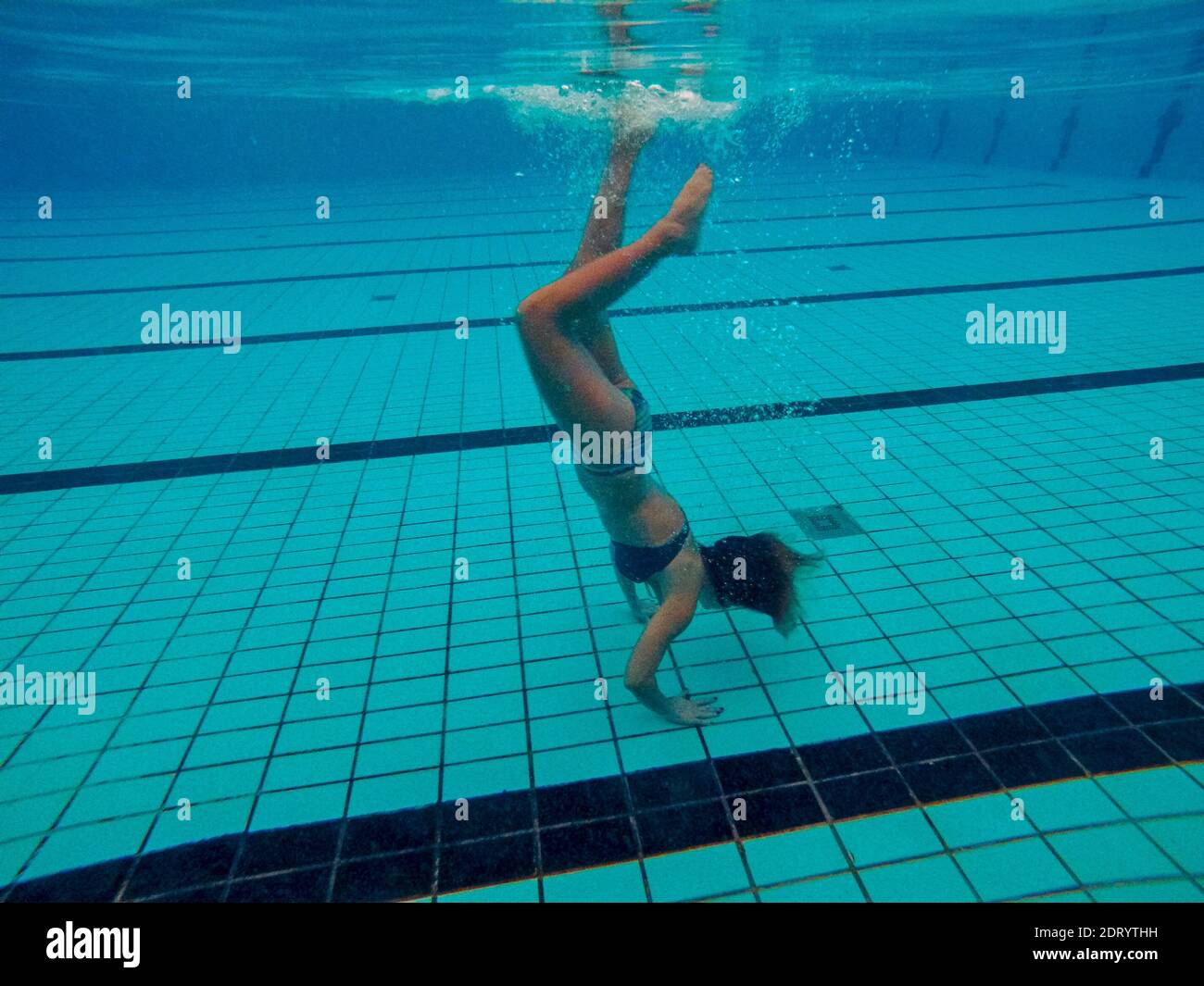 Woman Doing Handstand While Swimming In Pool Stock Photo Alamy