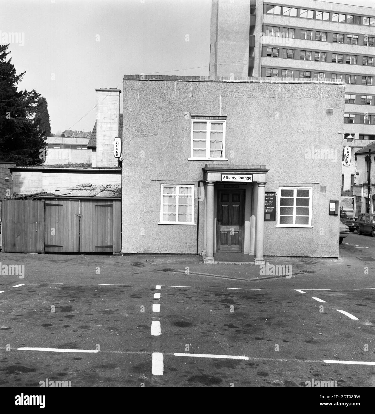 The Duke of York pub in Kingston, Yeovil. Photo taken in 1973. The main pub (see photos b and c) on the main road, was rebuilt in 1905 but this later rear elevation is more box-like. The sign over the door is for The Albany Lounge whereas the menu board advertises the Albany Bar and the perspex hanging sign has been smashed. The gallows sign on the front corner is for 'Lounge, Buffet Bar Car Park at Rear.' There is no brewery signage visible however photos c and d (maybe taken later as on 35mm negatives) show a Bass gallows sign. The corner shop sign is for what looks like Sophia Perrett.0085a Stock Photo