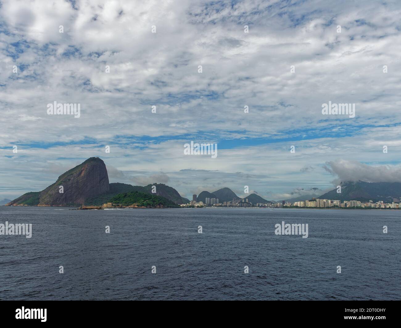 Copacabana beach, its Fort and the dramatic Pedra da Gavea Mountain seen from a Vessel heading into Rio Old Port. Stock Photo