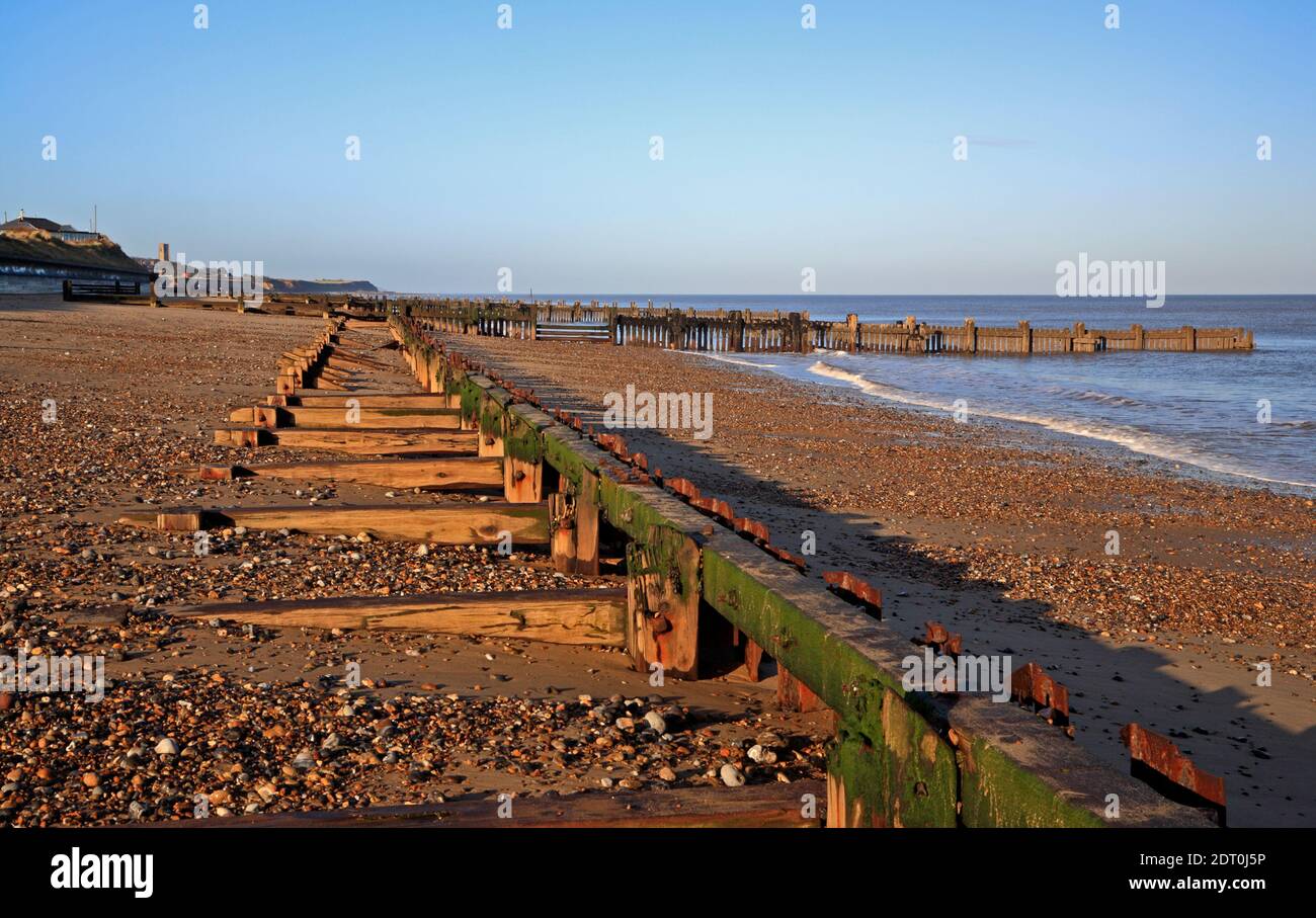 The remains of old sea defences running parallel to the coastline on the North Norfolk coast at Cart Gap, Happisburgh, Norfolk, England, UK. Stock Photo