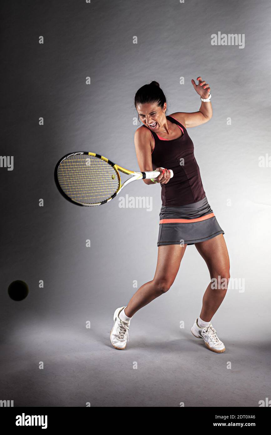 Professional female tennis player. Girl swinging racket Stock Photo - Alamy