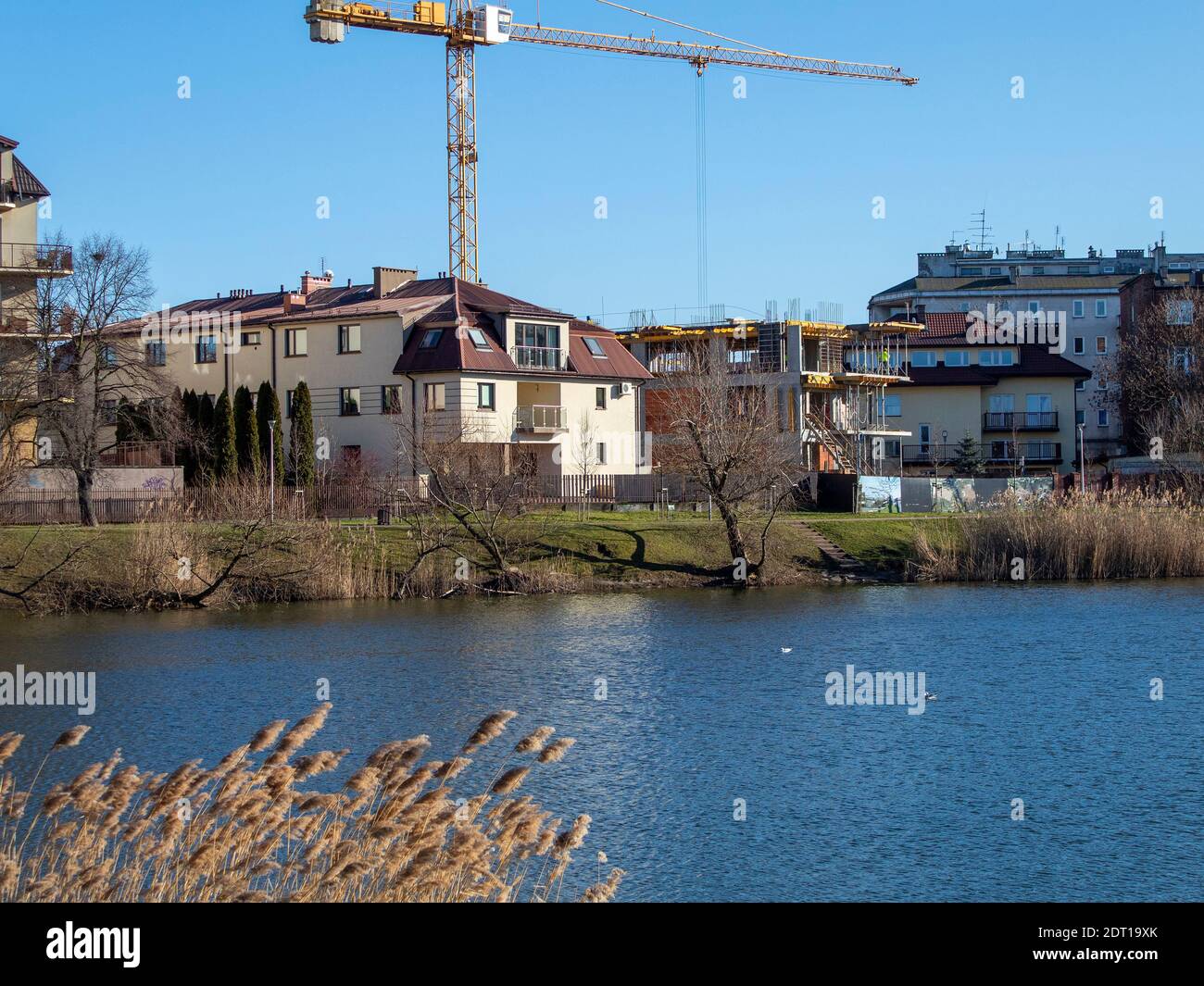 Illegal construction of a high-rise building in a city park near a river Stock Photo