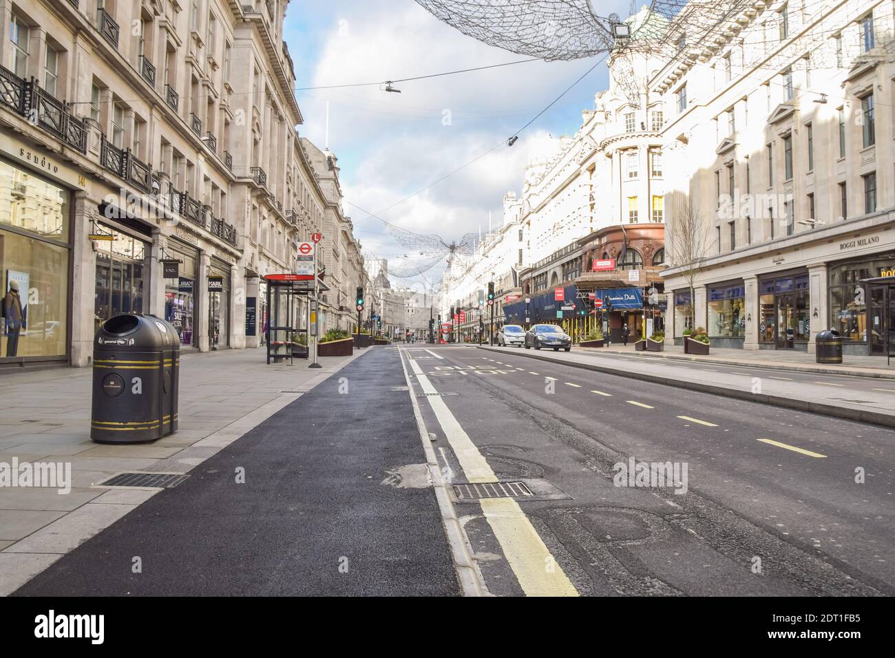 A view of a deserted Regent Street, as shops and businesses close once again. London has imposed even tougher restrictions as cases surge and a new strain of COVID-19 emerges in the capital and the South East of England. Stock Photo