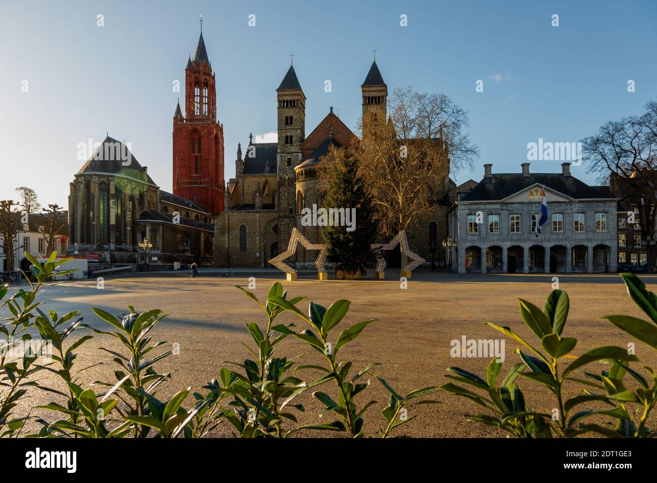 Vrijthof square in Maastricht decorated with a christmas tree during Covid19 lockdown. In the background the Sint Servaas basilica and Red Sint Jan Stock Photo