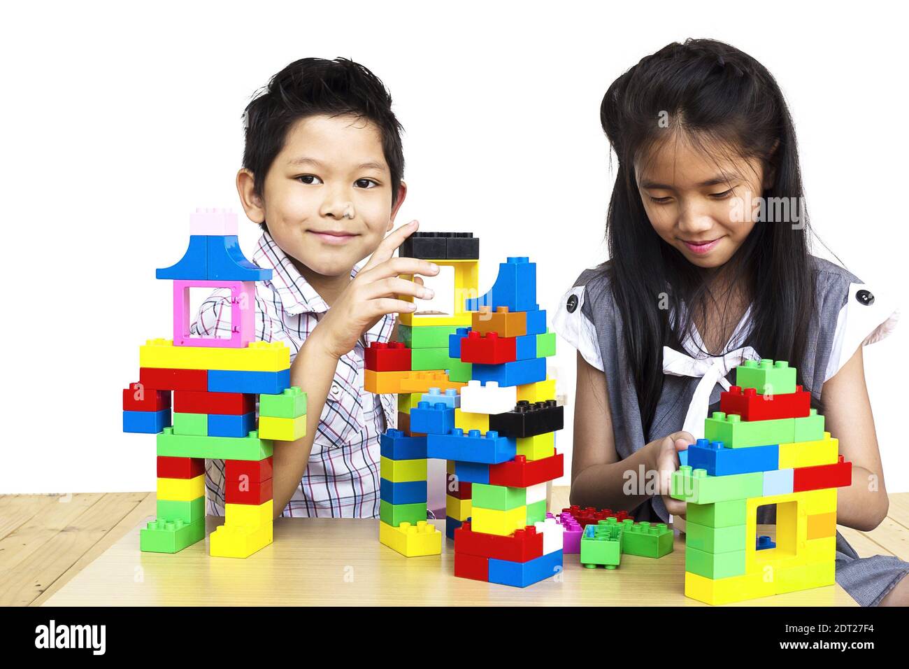 Smiling Siblings Playing With Toy On White Background Stock Photo - Alamy