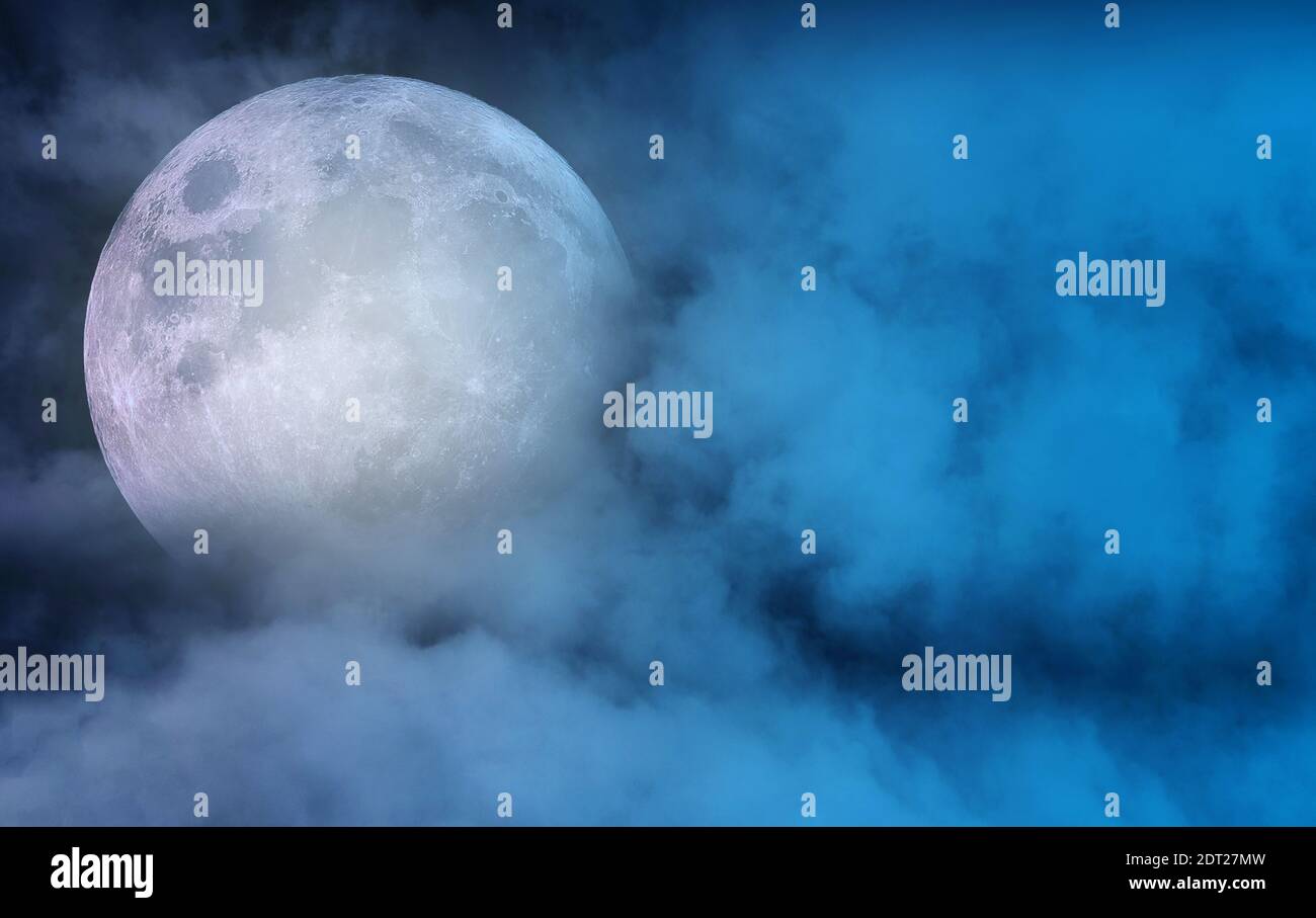 Big full moon with moon light covered by clouds in dark night sky, magic night time, space for text Stock Photo