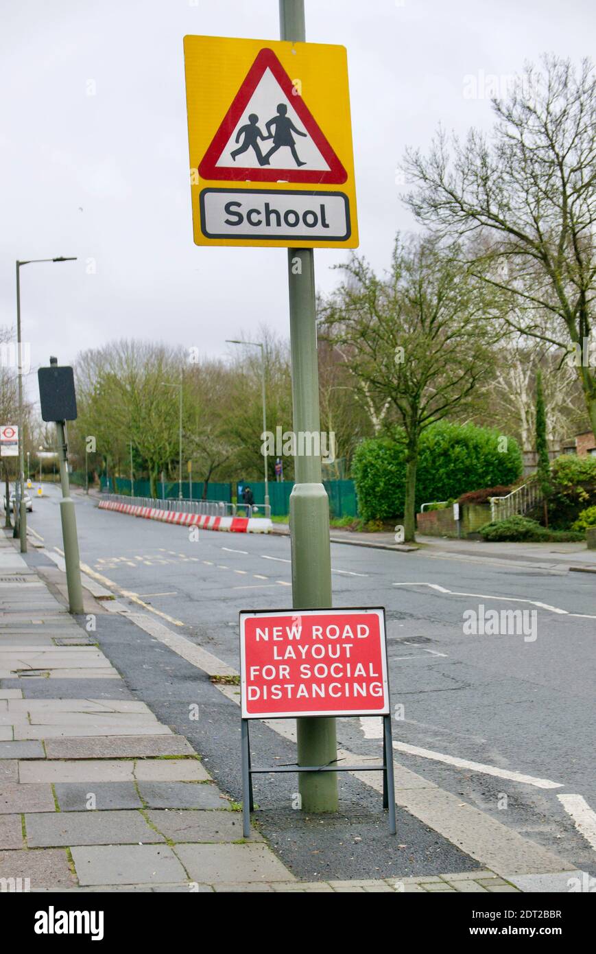 Social distancing pavement extension into the road to allow parents to drop off and collect children from school in covid safe manner. Barnet, London. Stock Photo