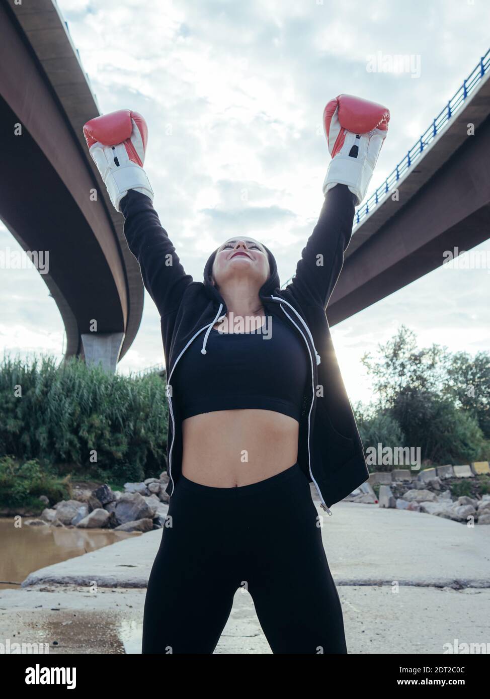 Boxer outdoors with arms raised Stock Photo Alamy