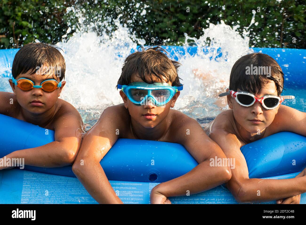 Boys in swimming pool, wearing goggles Stock Photo Alamy