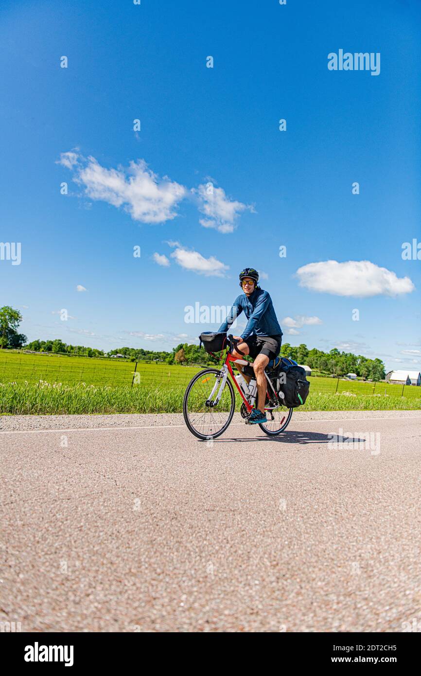 Cyclist on road, Ontario, Canada Stock Photo