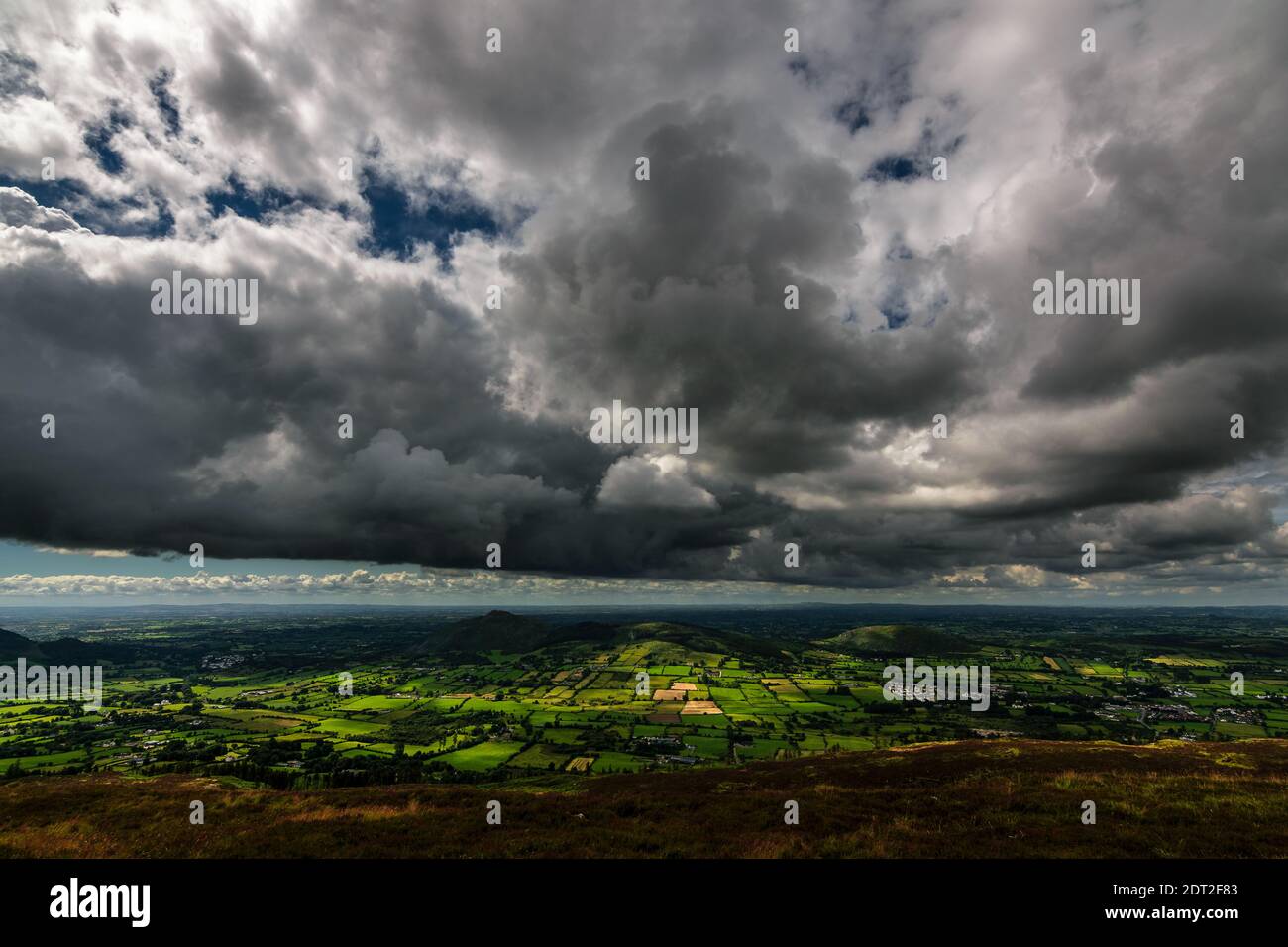 Storm in the sky, sunshine and rain under the clouds, view from top of the mountain Slieve Gullion in the south of County Armagh, Northern Ireland Stock Photo