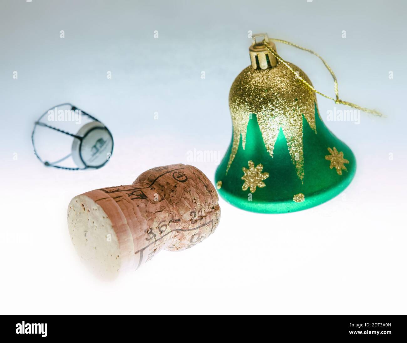 Party time, on the light table we see a champagne cork and a Christmas decoration. Stock Photo