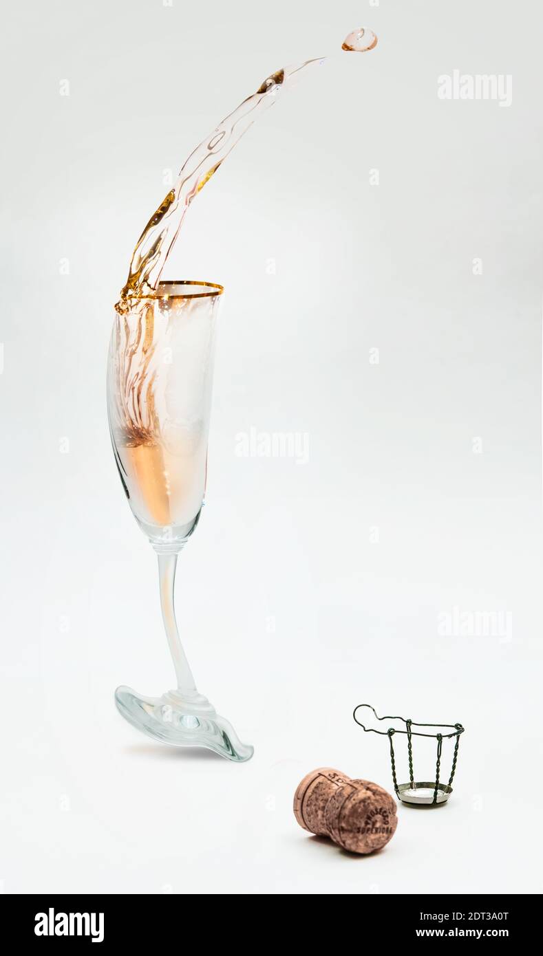 A cartoonish view of a glass of sparkling wine or champagne, losing its balance (due to excessive consumption) ...isolated. Copy-space. Stock Photo