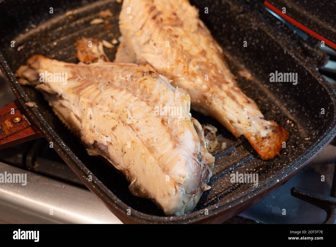 Cooking sea bass in a pan Stock Photo Alamy