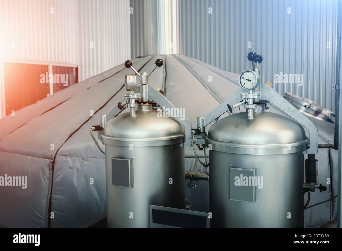 Manometer on brewery equipment steel cylinder with gas in and hop dispenser. Stock Photo