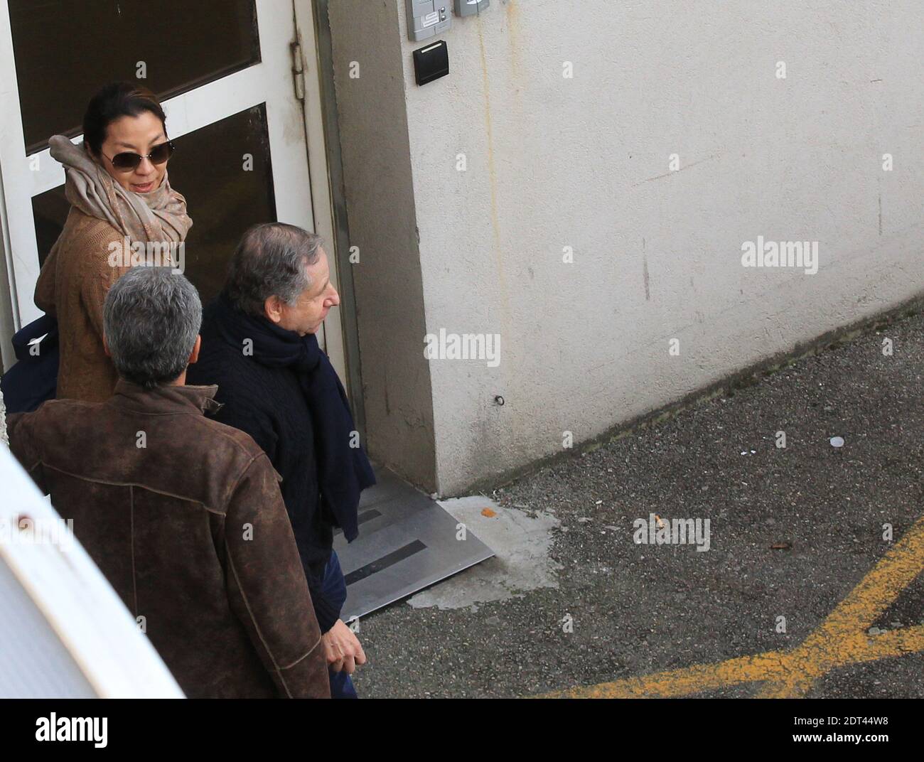 President of the Federation Internationale de l'Automobile (FIA) Jean Todt  and his wife, actress Michelle Yeoh, leave the 'Centre Hospitalier  Universitaire' (CHU) hospital in Grenoble, near the French Alps, France,  January 1,