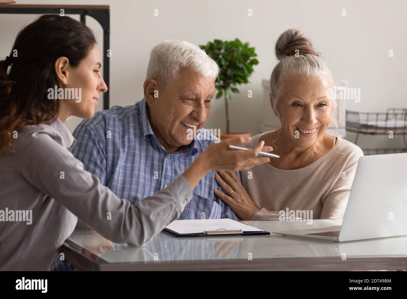 Female consultant have meeting with elderly couple Stock Photo