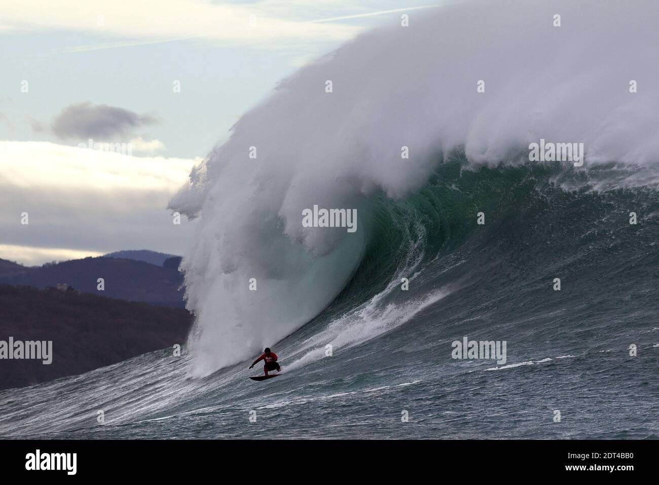 A man surfs the Belharra giant waves some two kilometers off the coast of the French basque country town of Urrugne near Saint-Jean-De-Luz, France on January 7, 2014. Thanks to certain climatic conditions in autumn and winter, a strong swell hits the Belharra Perdun underwater spur enabling a 10 to 15 metre wave to form. This wave is only surfed by experts who are towed out by a water scooter. Photo by Masurel/Photomobile/ABACAPRESS.COM Stock Photo