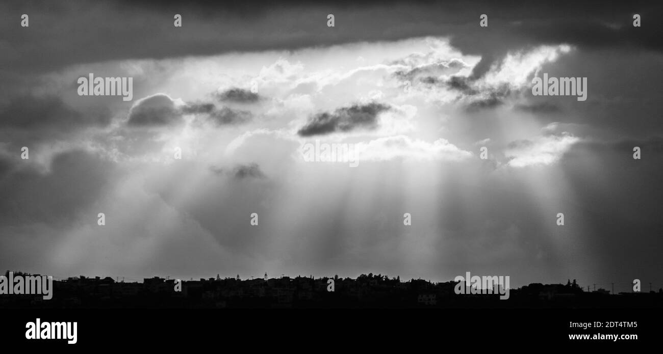 Dramatic sky with sun rays bursting through clouds Stock Photo - Alamy
