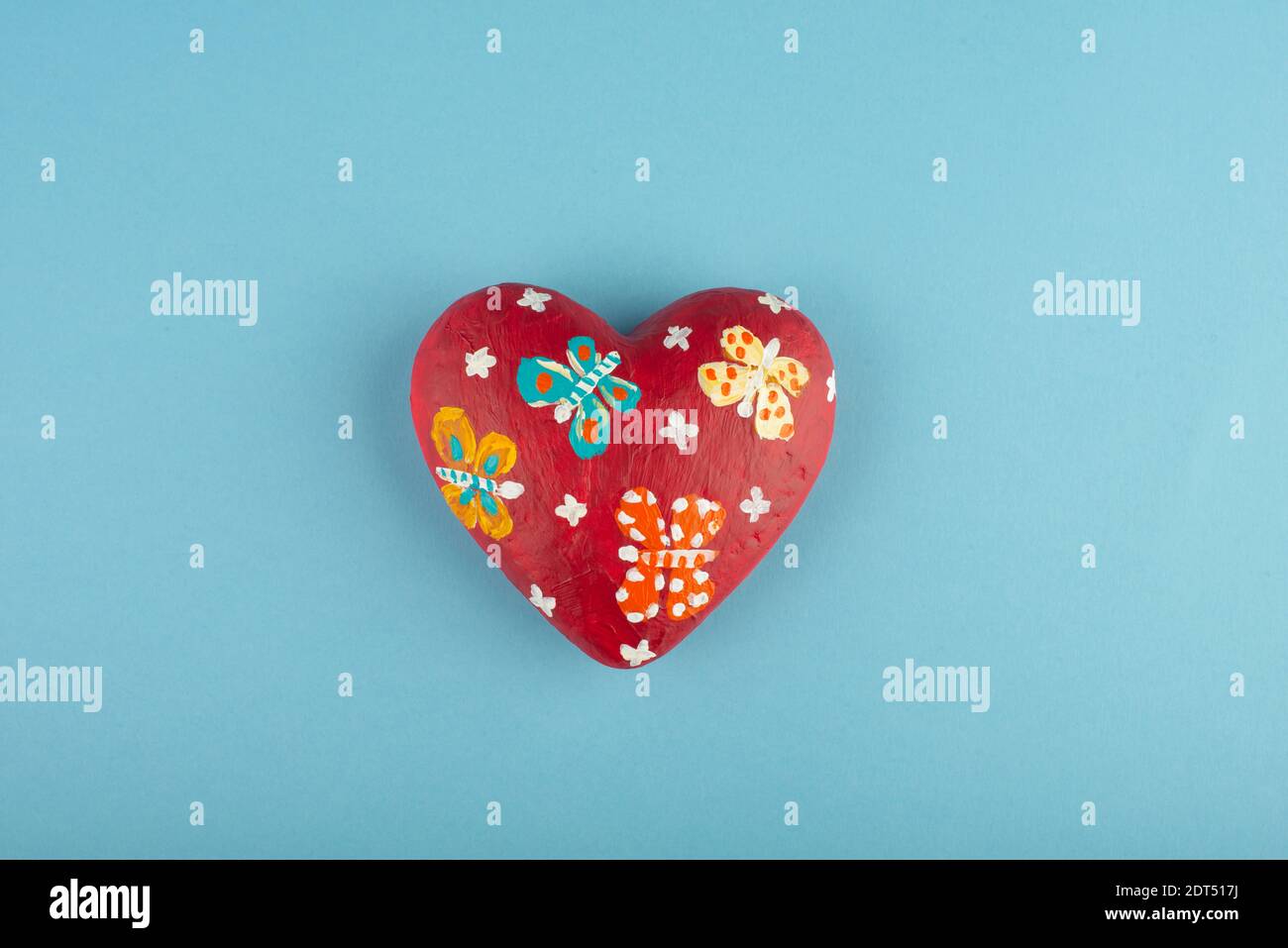 Colourful red heart isolated on light blue background. Stock Photo