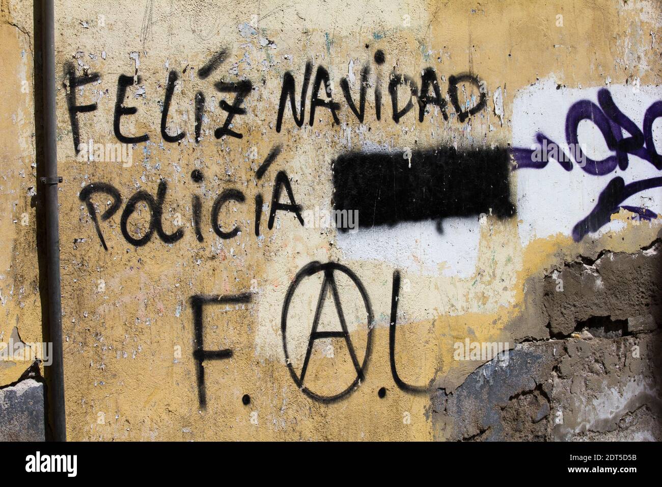 Merry Christmas police graffiti with an abusive term painted out.  Portuguese. Stock Photo