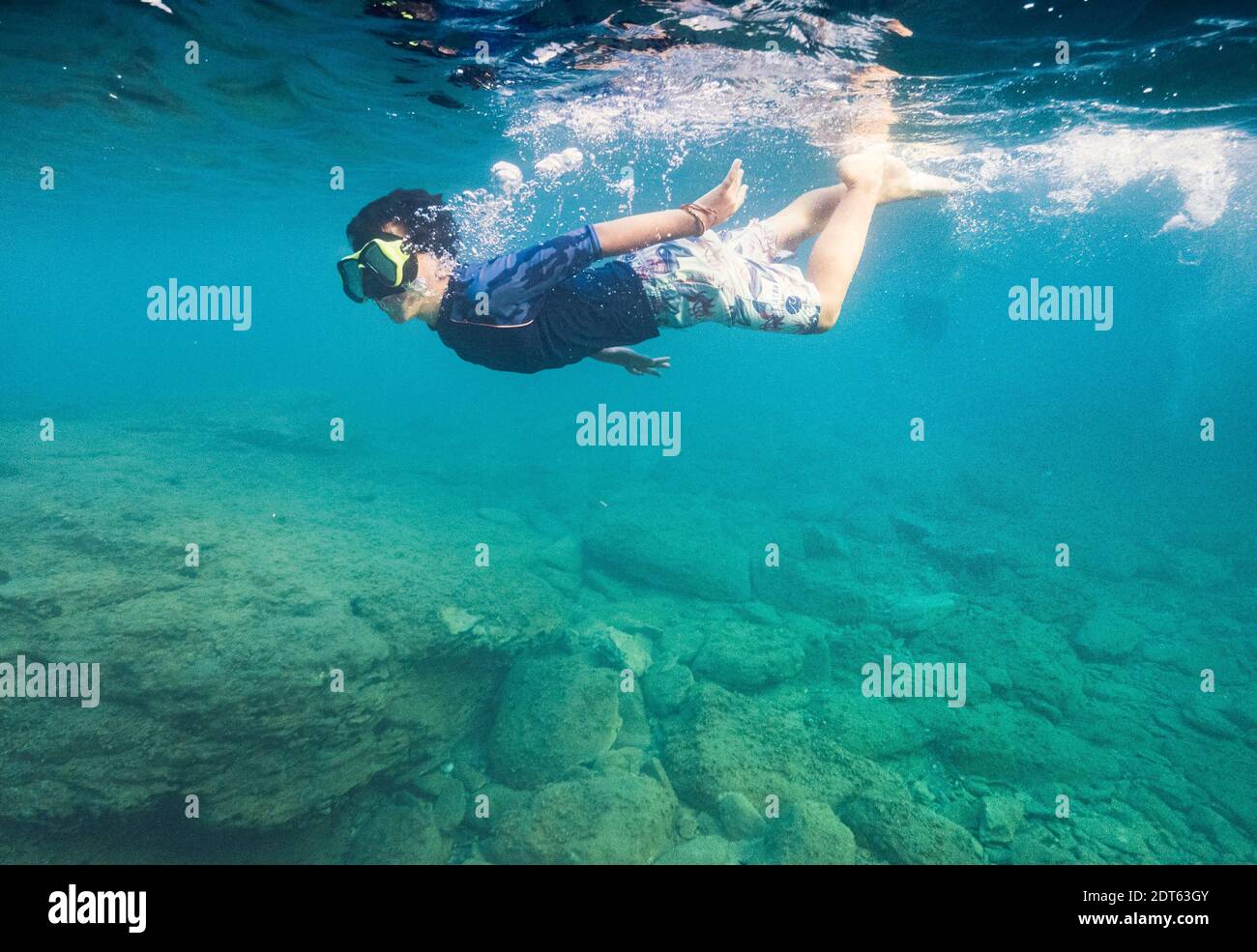 Boy wearing scuba mask swimming underwater Stock Photo Alamy