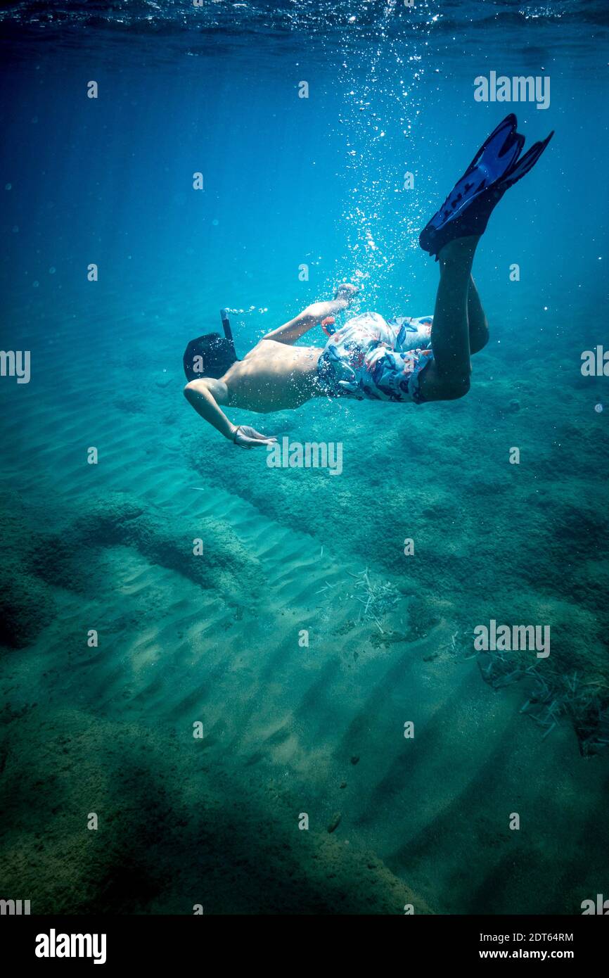 Boy wearing scuba mask swimming underwater Stock Photo Alamy