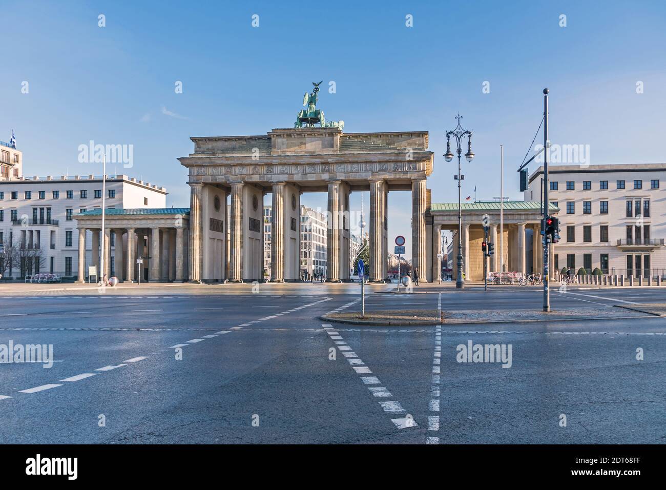 Berlin, Germany - December 18, 2020: Platz des 18. Maerz (18 of March Square) with the Brandenburg Gate, Hanukkah candlestick, decorated Christmas tre Stock Photo