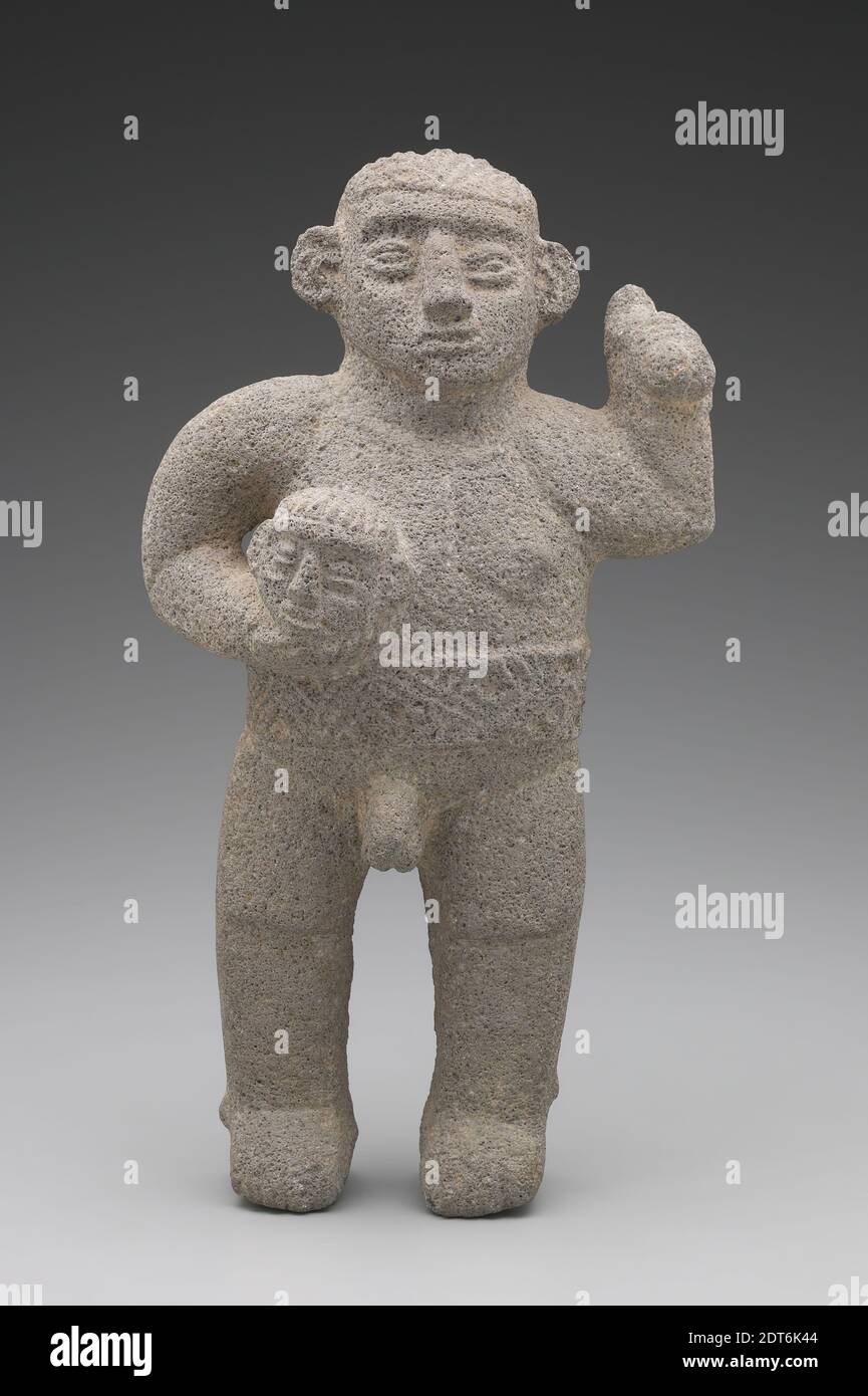 Maker: Unknown, Warrior with a Trophy Head, A.D. 900–1200, Volcanic rock, 38.1 × 20.96 × 12.7 cm (15 × 8 1/4 × 5 in.), Images of trophy bearers carrying an axe in one hand and a severed head in the other commonly occur in Costa Rican sculpture. The head that this warrior is holding, smaller than life-size, may be a shrunken one. Trophy heads were given as prizes in the ballgame, suggesting that this trophy bearer might have been a ballgame victor, his belt perhaps echoing a ballplayer’s yoke. , Made in Costa Rica, Costa Rica, Atlantic Watershed, Guapiles, Period VI, Early Postclassic Period Stock Photo