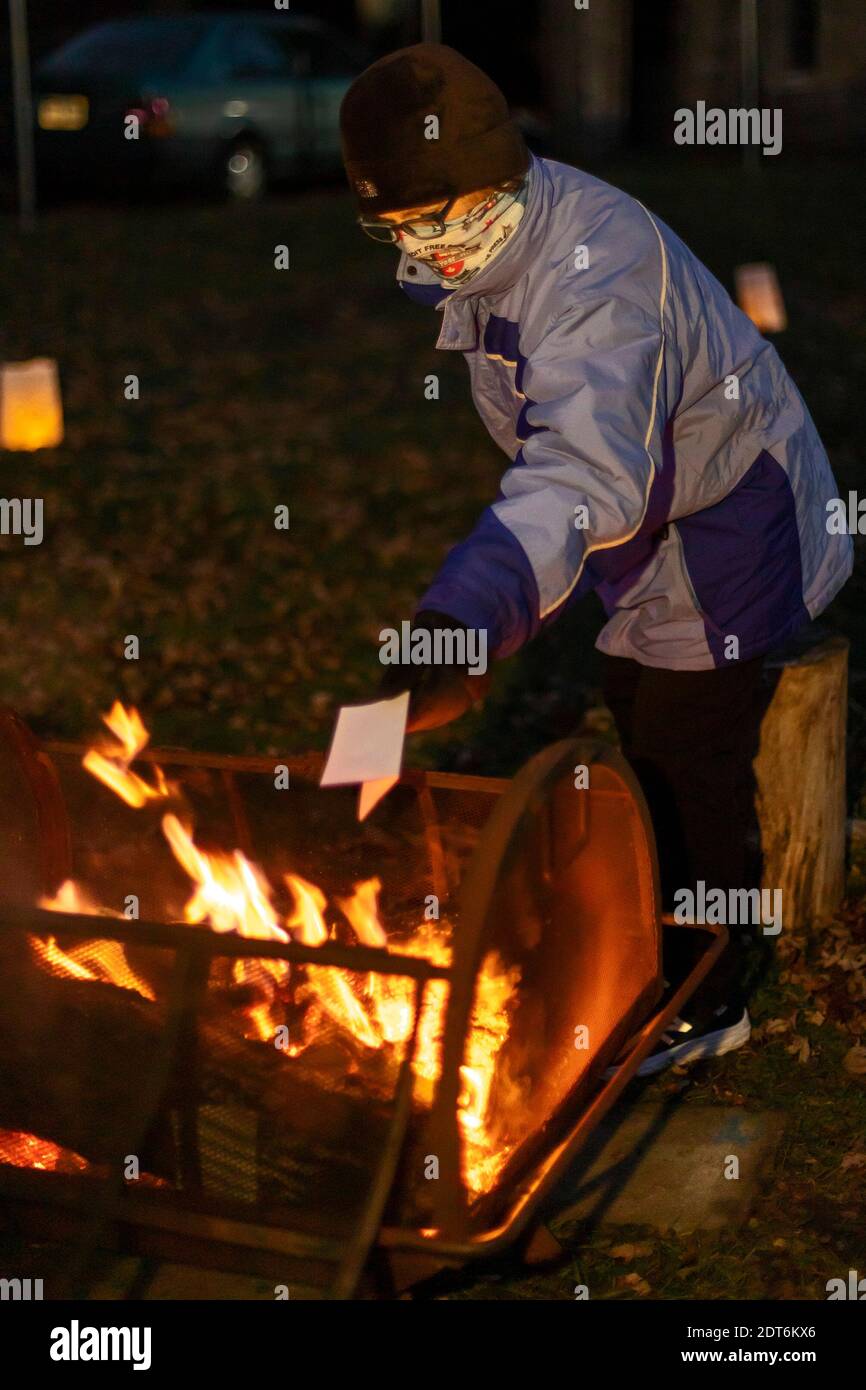 Detroit, Michigan, USA. 20th Dec, 2020. At a Winter Solstice gathering, neighbors wrote down and burned what they wanted to forget about 2020, and posted their hopes for 2021 on a tree of lights. Credit: Jim West/Alamy Live News Stock Photo