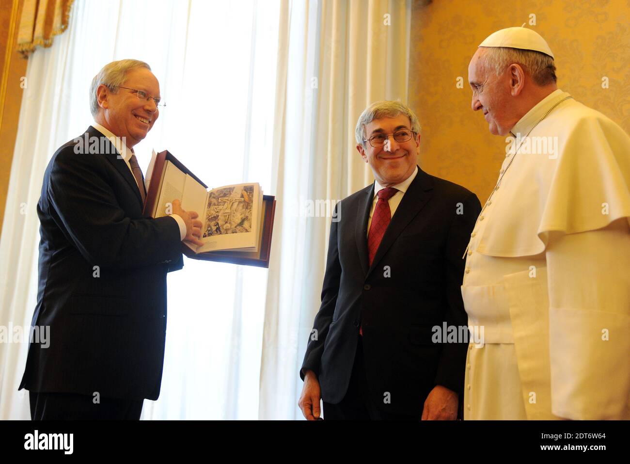 David Inlander, Chair of AJC's Interreligious Affairs Commission and Stanley Bergman AJC President presented to Pope Francis a copy of the Jewish Museum in New York's recent exhibit book, Chagall: Love, War and Exile, which includes one of the Pope's favorite works of art, Marc Chagall's 1938 painting, White Crucifixion.Pope Francis Receives American Jewish Committee (AJC) Leadership Delegation at Vatican on February 13, 2014. A pioneer in advancing Catholic-Jewish relations over many decades, AJC enjoys close, cooperative relations with the Vatican, as well as with American Catholic leadershi Stock Photo