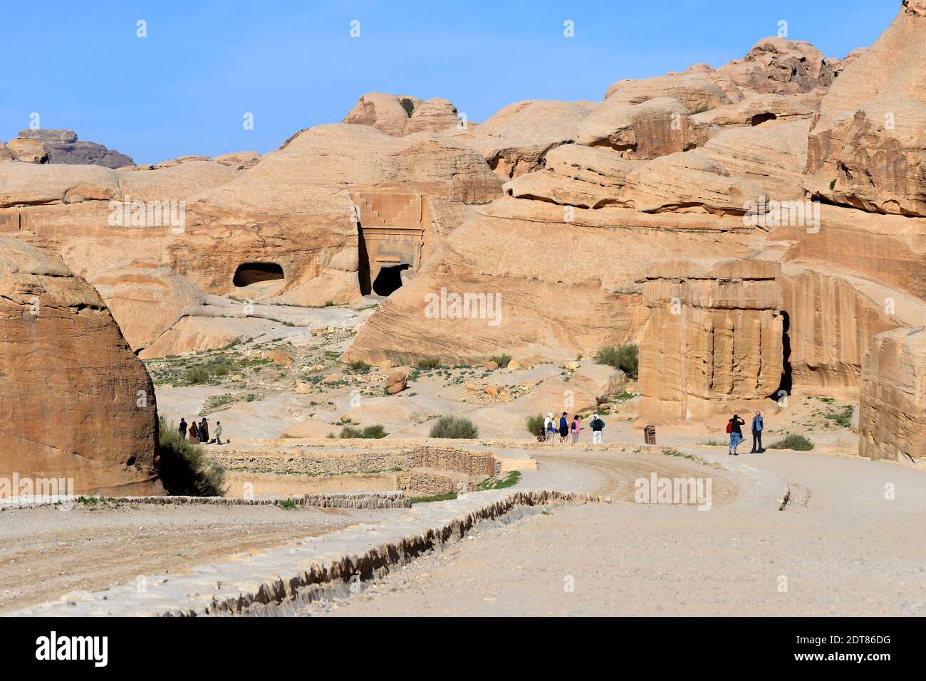 Djinn blocks and ancient caves by the tourist walk to Petra know as Bab as-Siq, the path to the Siq. The main entrance trail. Tourists gateway. Stock Photo