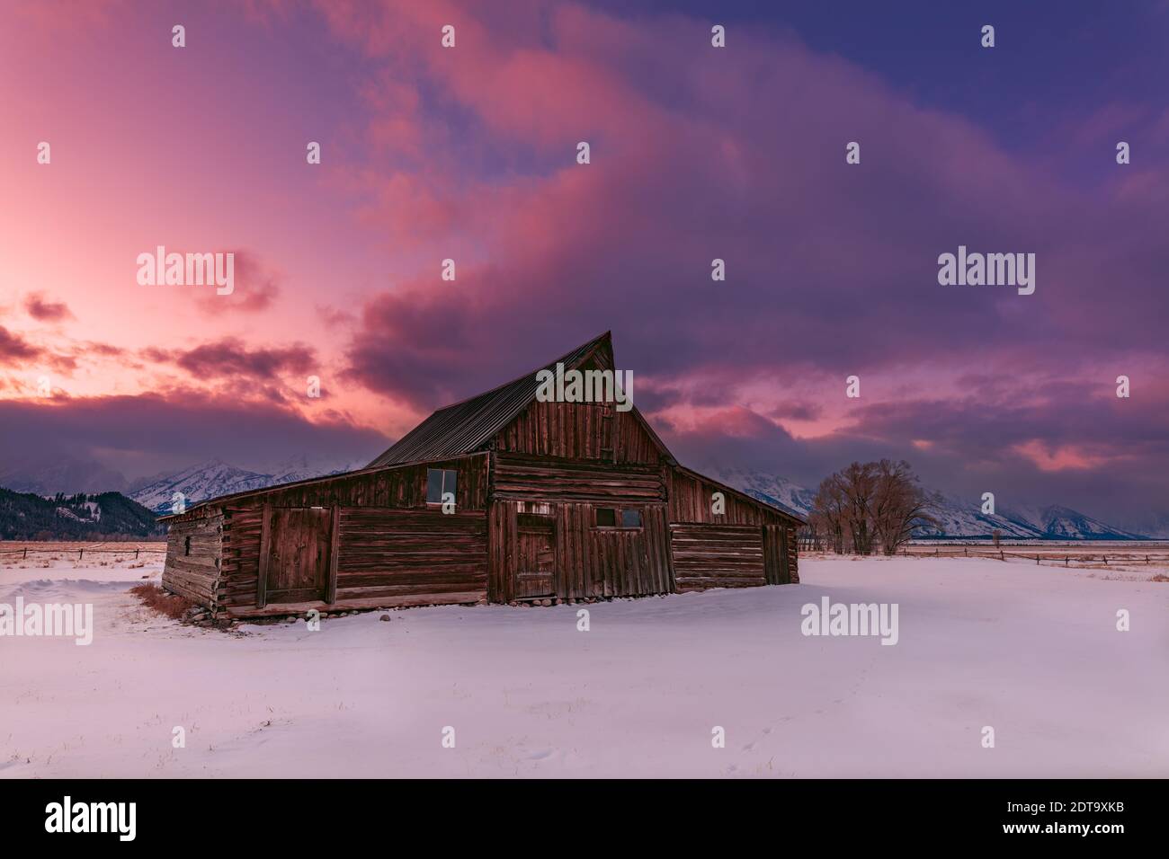 Scenic winter landscape with Moulton Barn at sunset on Mormon Row in Grand Teton National Park, Jackson Hole, Wyoming, USA Stock Photo