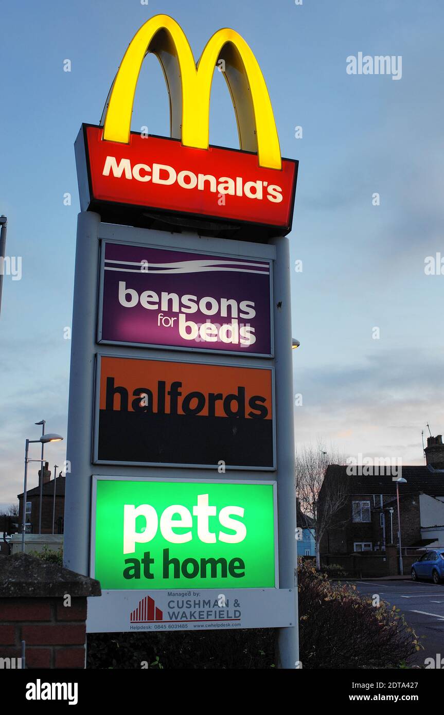 An advertising billboard for stores in the retail park at sundown. Stock Photo