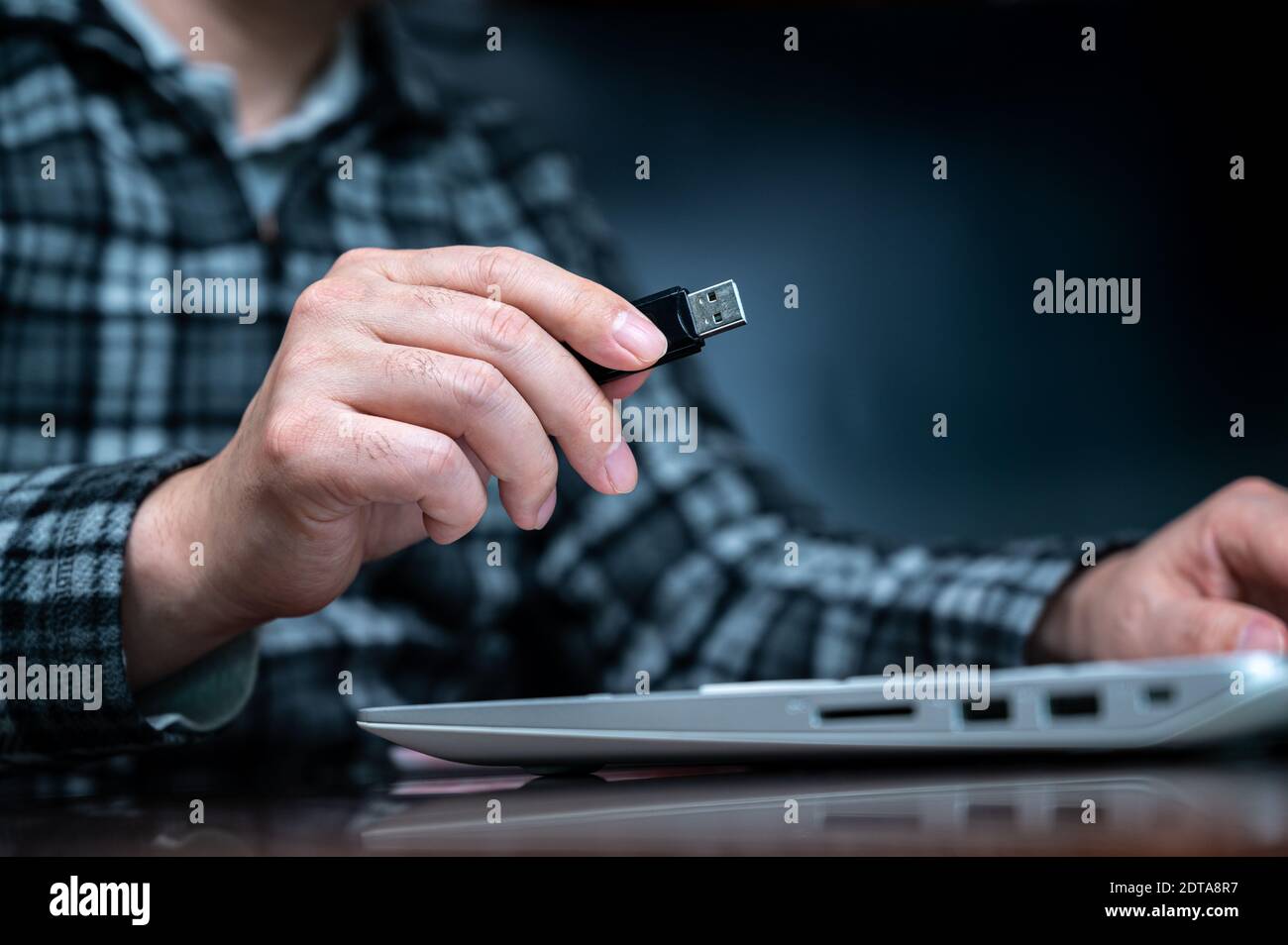 The hand of a person using a USB memory. Cyber Information Protection Concept. USB Selection Focus. Stock Photo